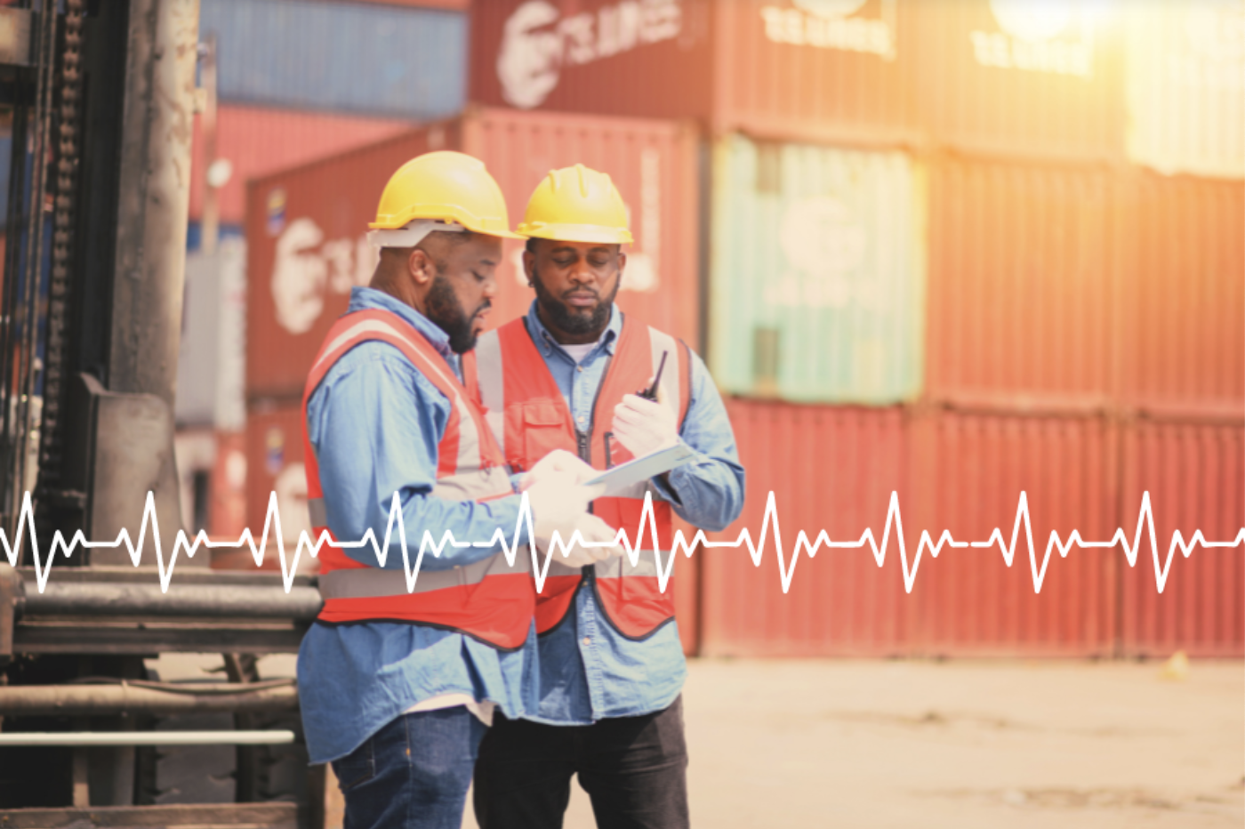 Two people on a construction site talk, with a heart rate monitor line transposed on the lower part of the image, symbolizing the link between workplaces and health outcomes.